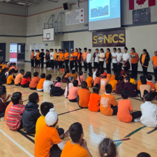 Children wearing orange shirts.