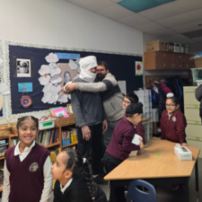 Adults and children in a classroom.